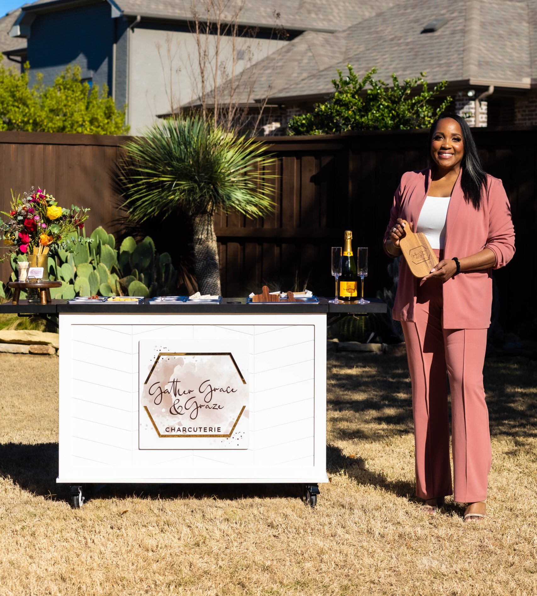 Karla Turntine, founder of Gather Grace & Graze, beside her mobile charcuterie cart